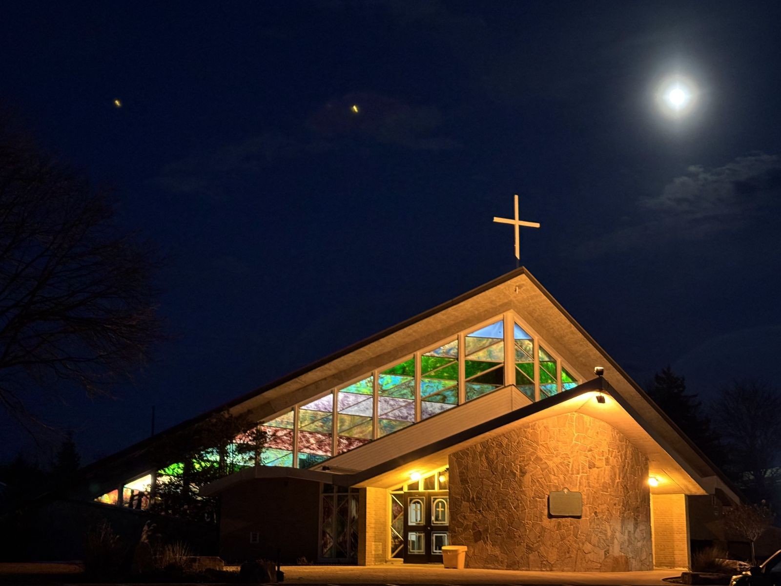 A picture of the exterior of St. John the Evangelist Church with the night sky in the background